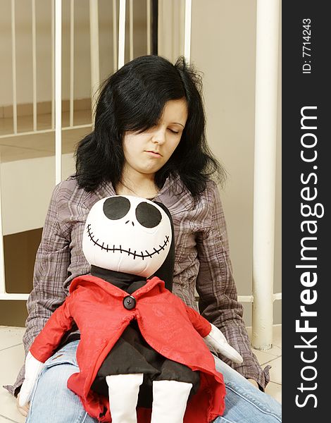 Sad teenager with a doll