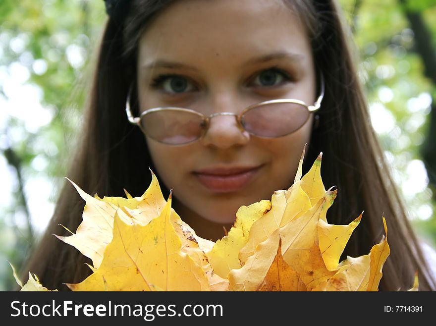 Pretty girl with autumn leaves