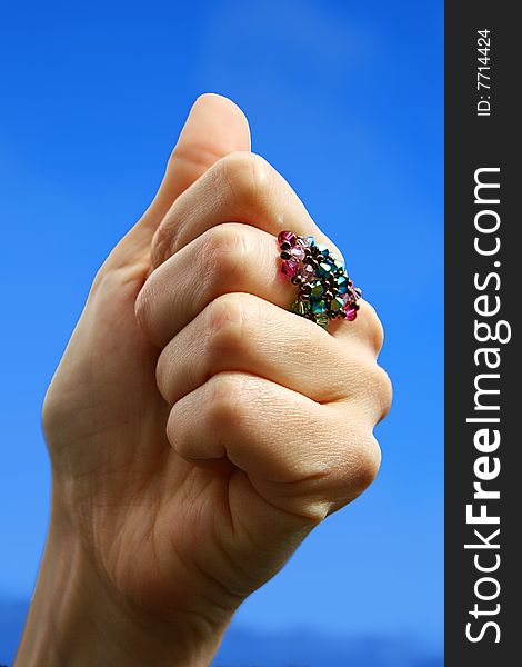 An image of a hand with a ring doing a positive gesture. An image of a hand with a ring doing a positive gesture
