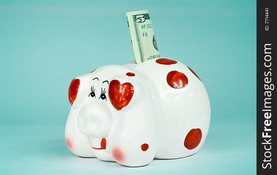 Porcelain piggy bank isolate on cyan