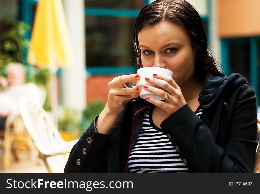 Beautiful girl has coffee break. Beautiful girl has coffee break