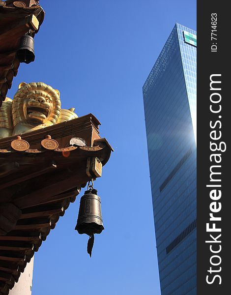 Temple bell and building with blue sky.