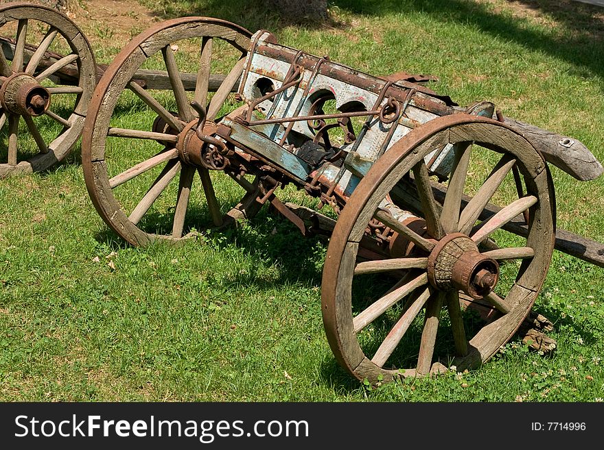 Old coach on green grass