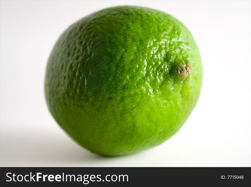 A whole lime on a white background