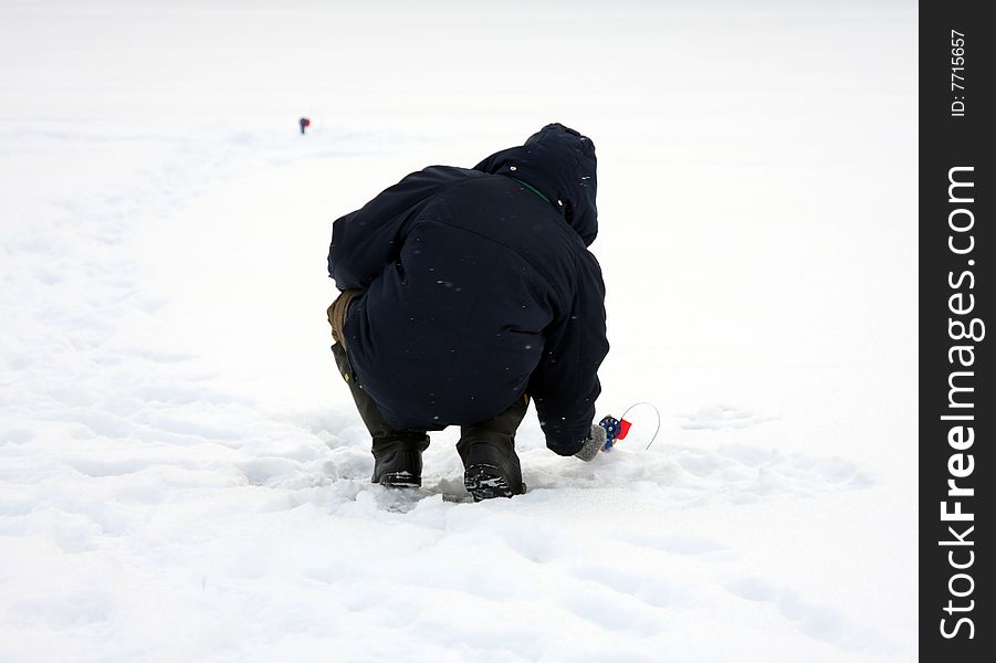 Fisherman checks bait. Winter fishing.