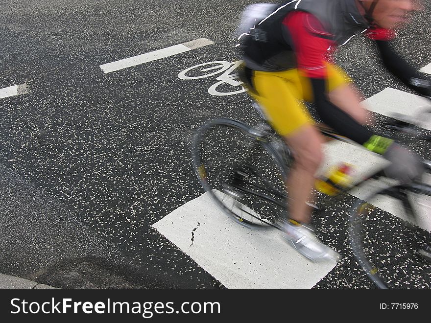 Cyclist race. Bike race in Denmark. Cyclist are passing a bike sign on the road. Speedy motion blur.