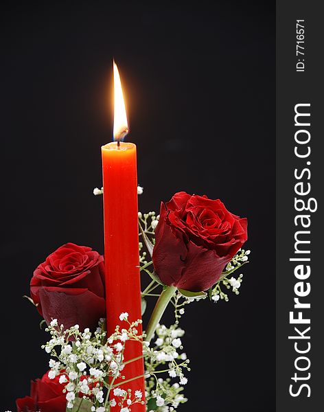 Two Red Roses with candle  isolated on white