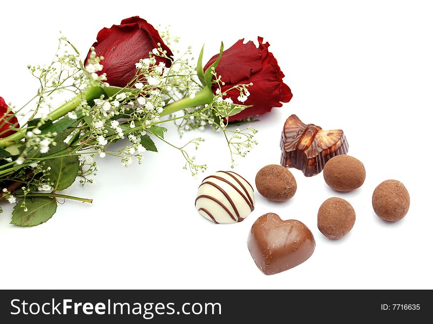 Two Red Roses isolated on white with chocolates