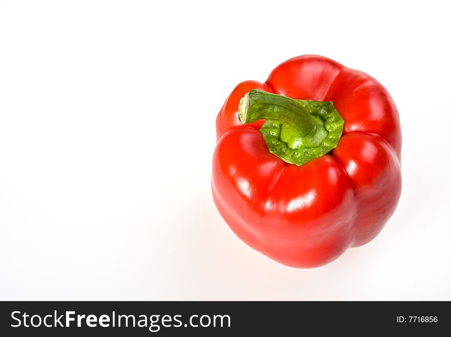 Single red bell pepper isolated on white