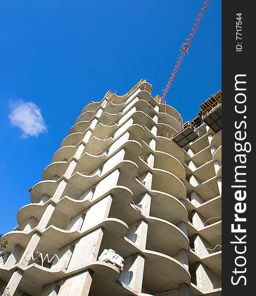 Reinforced concrete building under construction and tower crane