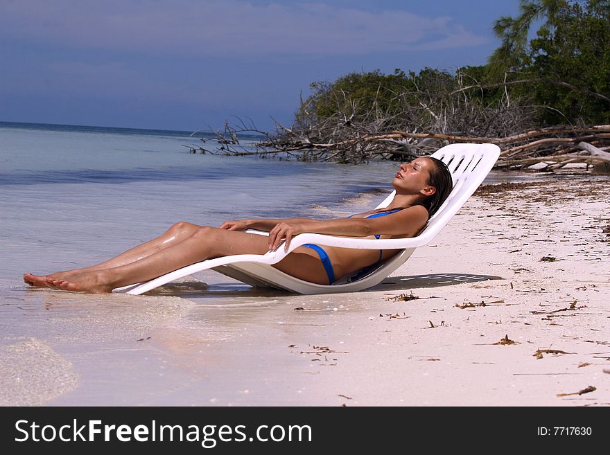 Woman relaxing on the beach in the sun