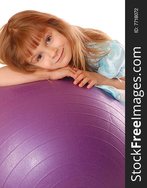 A 4 year old girl with a big violet ball. A 4 year old girl with a big violet ball