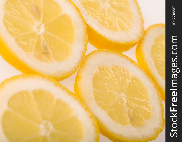 Five slices of lemon isolated on white background