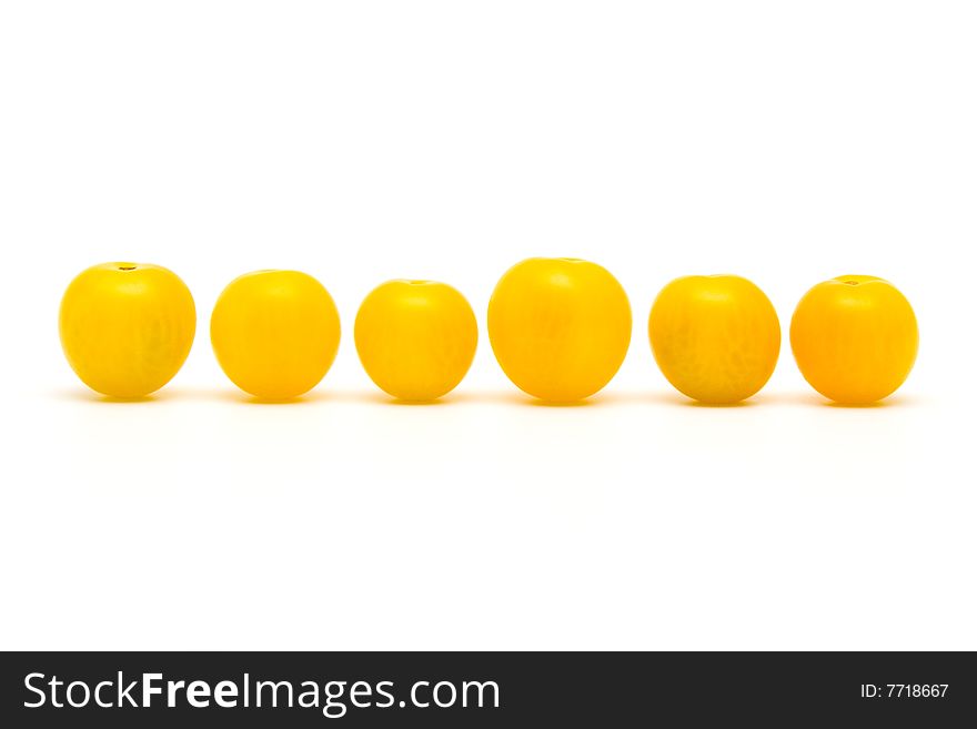 Yellow tomatoes on white background.