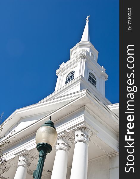 White church steeple against a dark blue sky