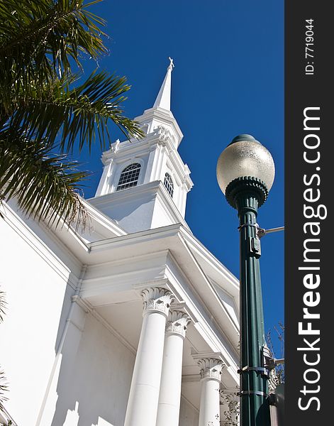 White church steeple against a dark blue sky