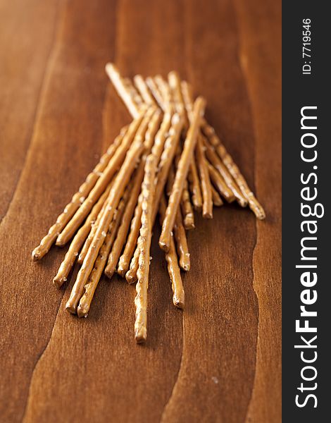 Pile of salted sticks on wooden background