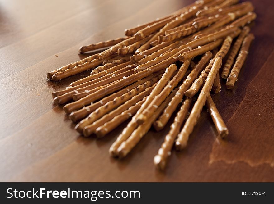Pile of salted sticks on wooden background
