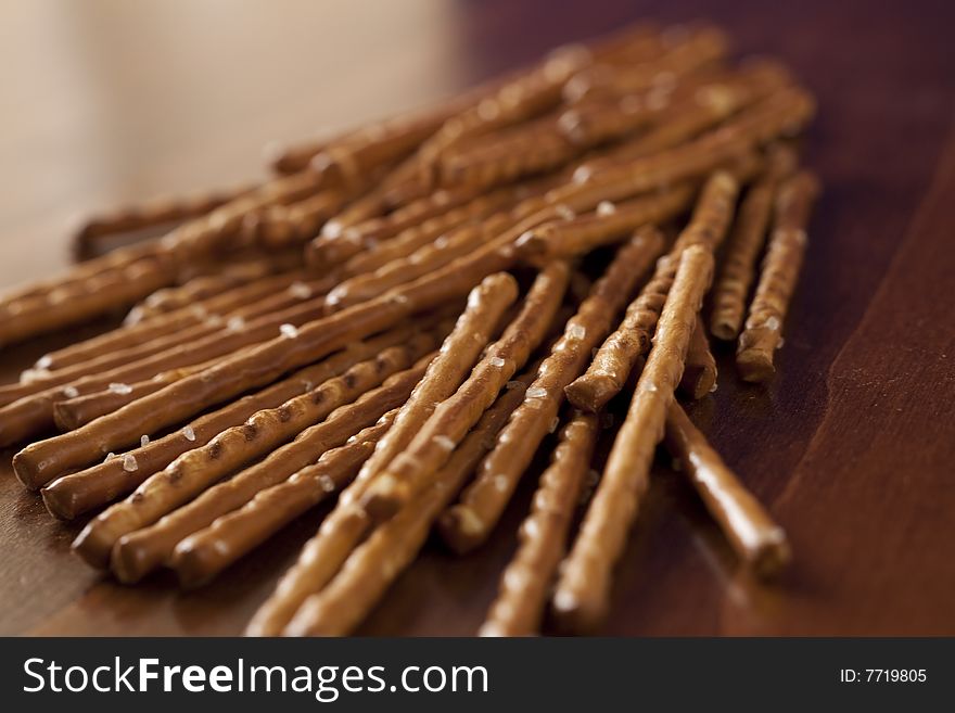 Pile of salted sticks on wooden background