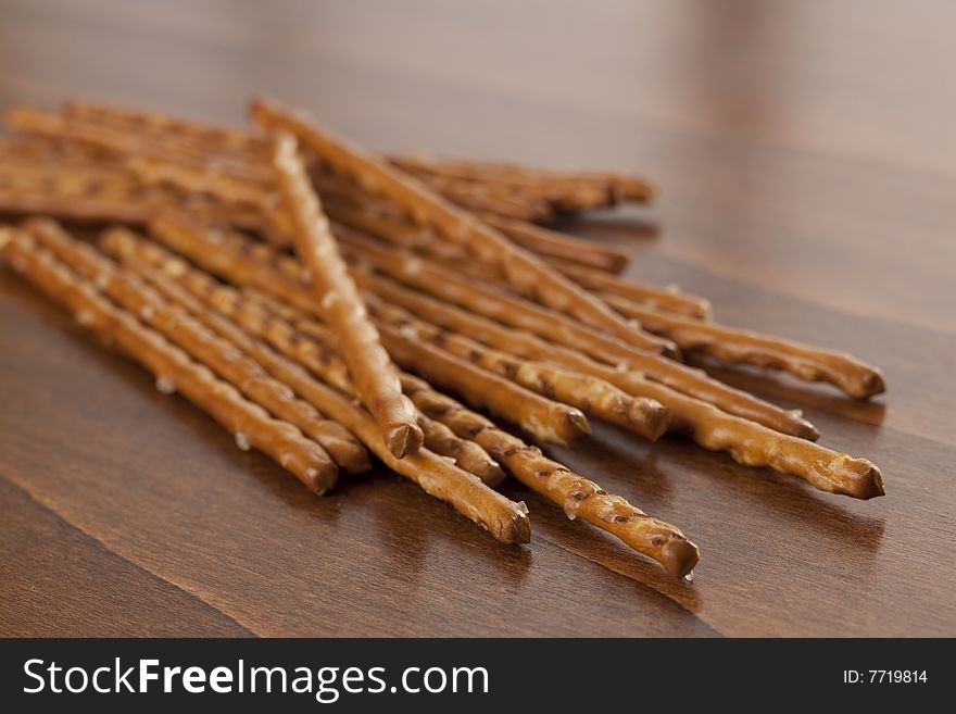 Pile of salted sticks on wooden background