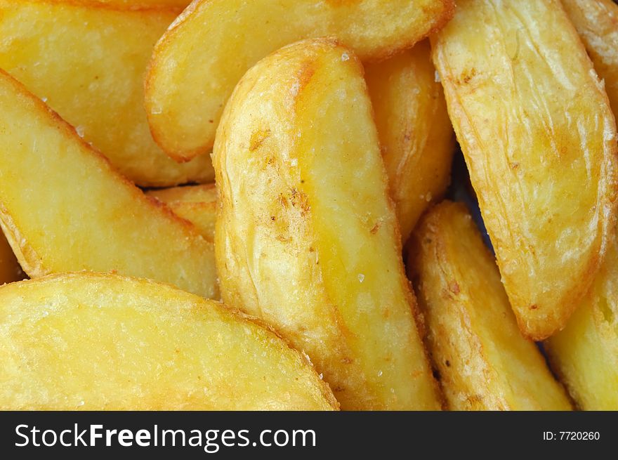 Fried potato closeup background, large slices