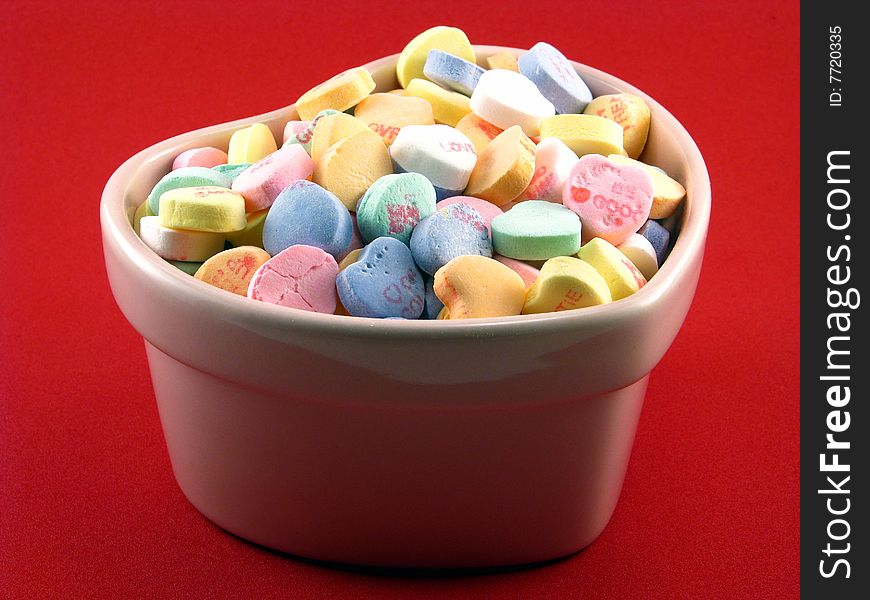 Valentine conversation hearts in a heart shaped bowl