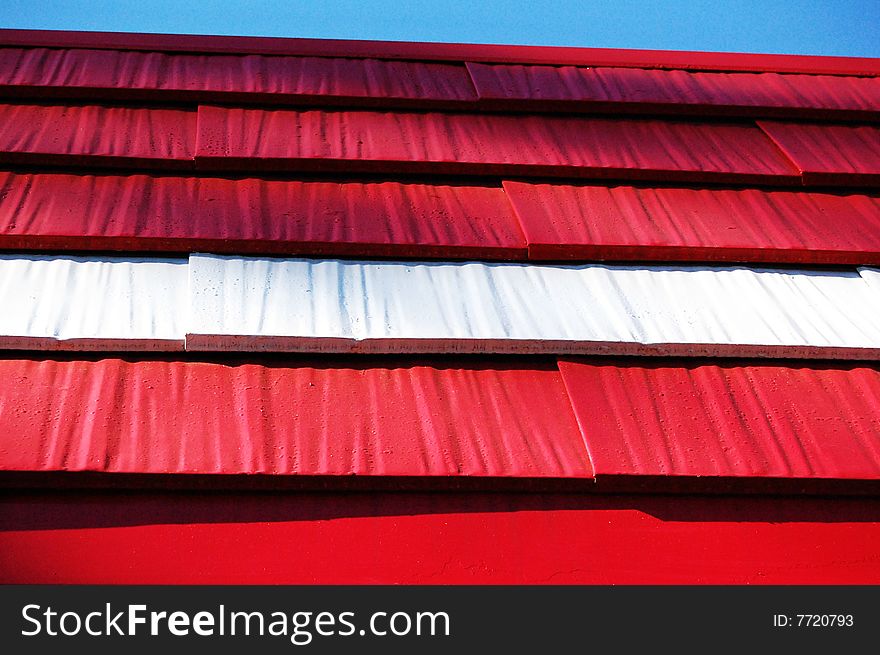 Close up of a portion of a red and white roof