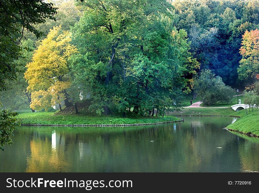 A view of a park lake with fog in autumn. A view of a park lake with fog in autumn