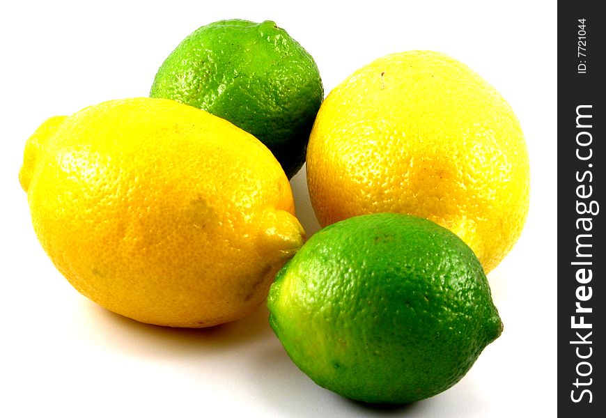 An arrangement of fresh lemons and limes on a white background