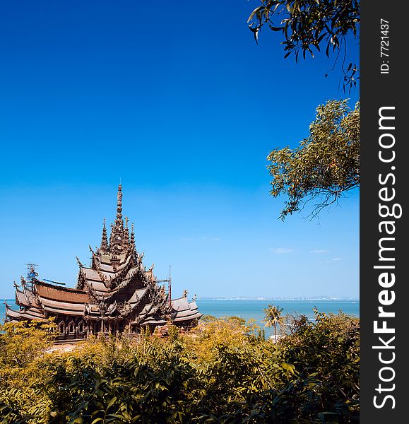 In Thailand in the city of Pattaya the sanctuary of truth is a wooden construction high of 105 meter covered with wooden carved sculpture; view of the sculpted roof. In Thailand in the city of Pattaya the sanctuary of truth is a wooden construction high of 105 meter covered with wooden carved sculpture; view of the sculpted roof