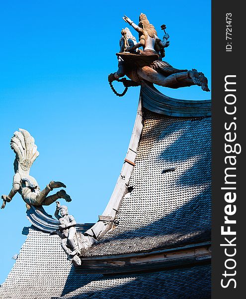 In Thailand in the city of Pattaya the sanctuary of truth is a wooden construction high of 105 meter covered with wooden carved sculpture; view of the sculpted roof. In Thailand in the city of Pattaya the sanctuary of truth is a wooden construction high of 105 meter covered with wooden carved sculpture; view of the sculpted roof