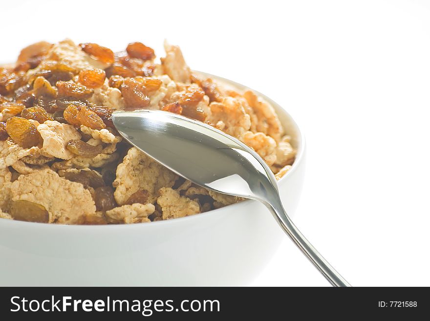Bowl of cereal with raisins, milk and orange juice