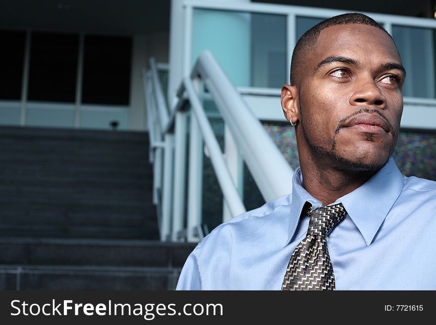 Handsome young businessman glancing away. Handsome young businessman glancing away