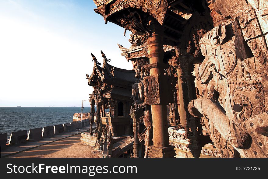 In Thailand in the city of Pattaya the sanctuary of truth is a wooden construction high of 105 meter covered with wooden carved sculpture; view of the sculpted roof. In Thailand in the city of Pattaya the sanctuary of truth is a wooden construction high of 105 meter covered with wooden carved sculpture; view of the sculpted roof