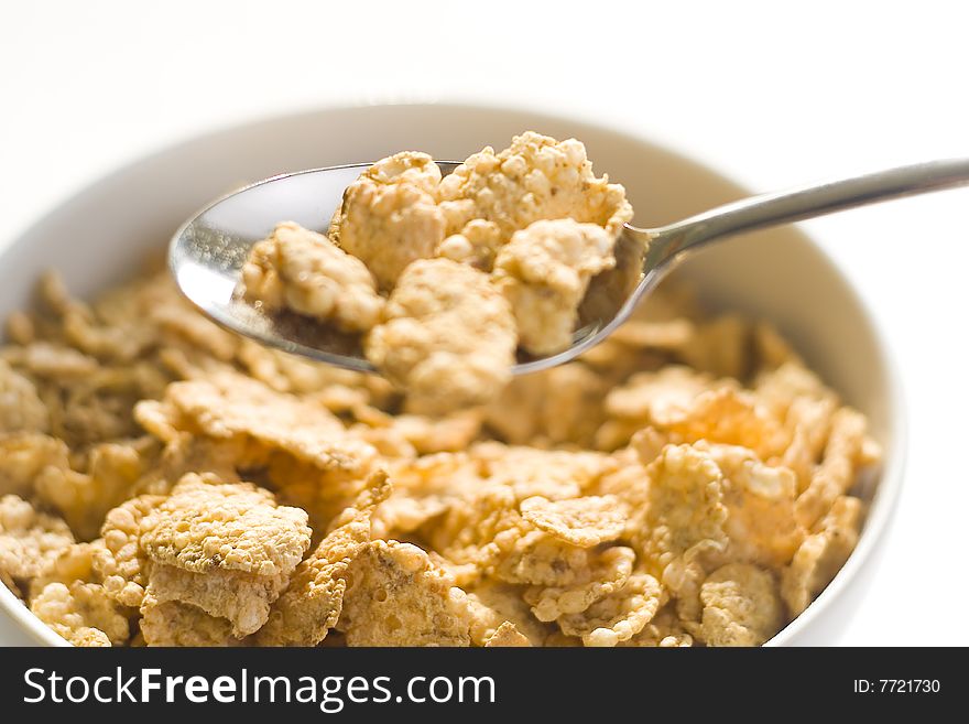 Bowl of cereal with raisins, milk and orange juice