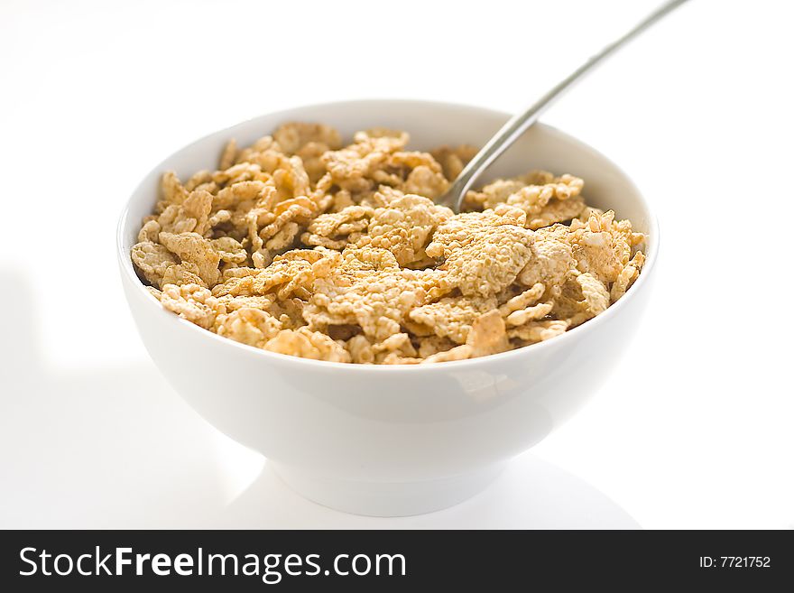 Bowl of cereal with raisins, milk and orange juice