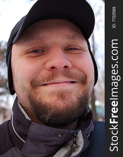 Portrait of happy young man with baseball cap. Outdoors. Portrait of happy young man with baseball cap. Outdoors.