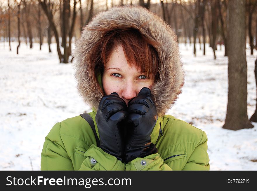 Portrait of young frozen woman in green jacket