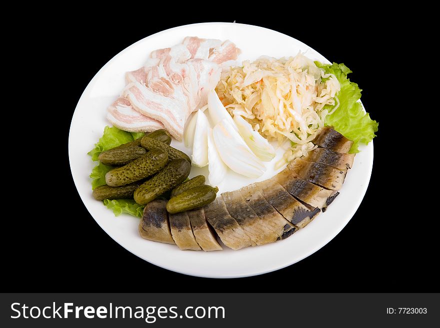 Sliced herring served with vegetables on black