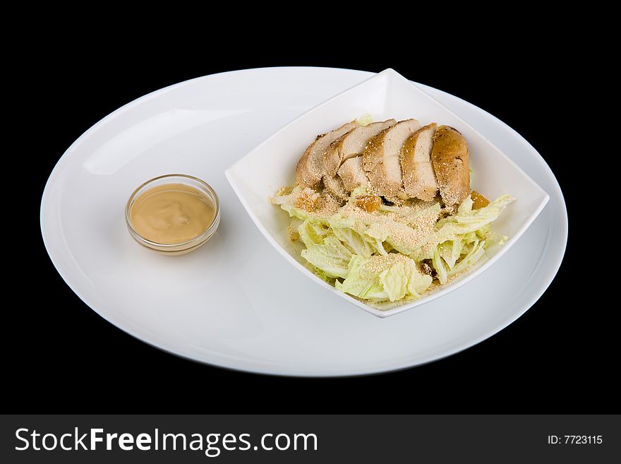 Meat with vegetables over black background