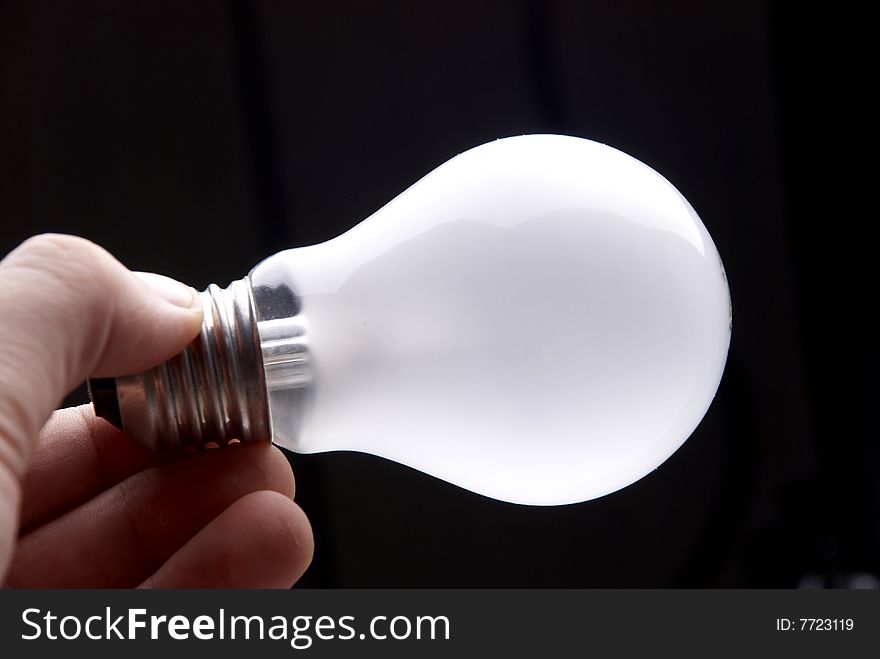 Hand holding a light bulb