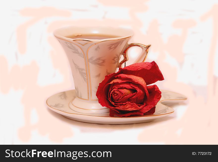 The dried rose and cup with tea. The dried rose and cup with tea