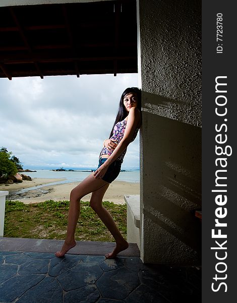 Outdoor asian woman relaxing by the beach. Outdoor asian woman relaxing by the beach