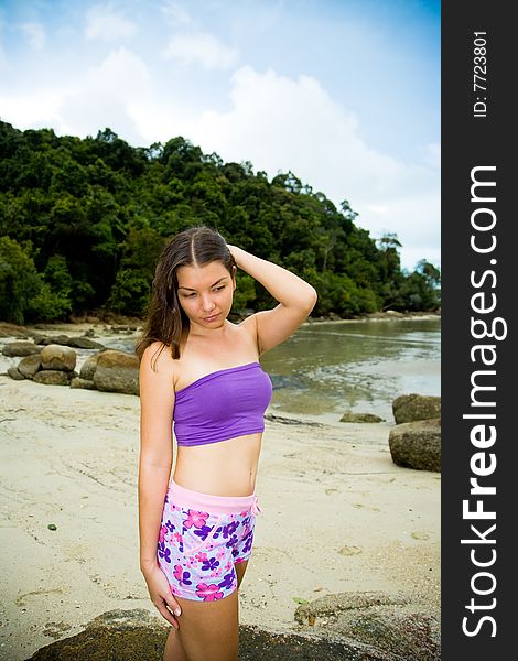 Outdoor asian woman relaxing by the beach. Outdoor asian woman relaxing by the beach