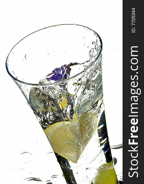 Glass with water and lime on the white background