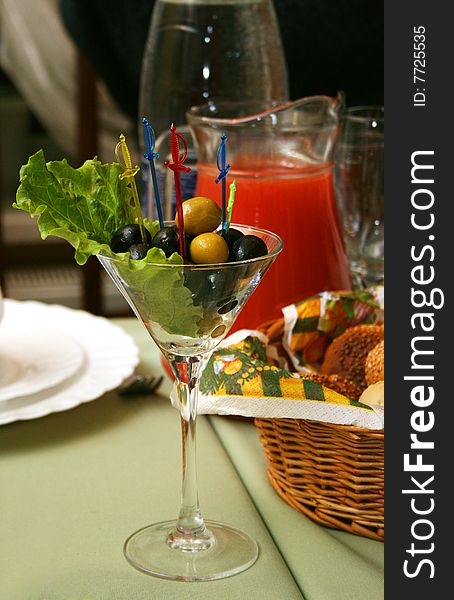Olives in a glass on a celebratory table