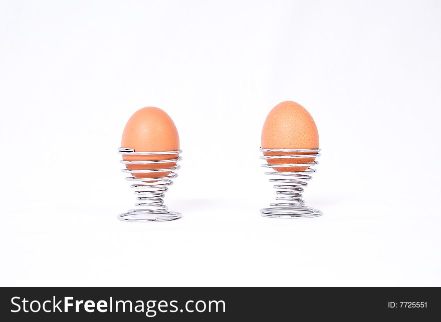 Two boiled eggs in modern spiral eggcups.