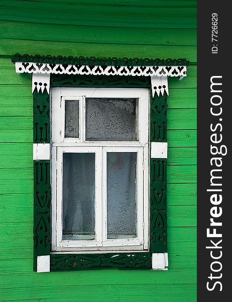 House window in the Russian village, decorated with a carving. House window in the Russian village, decorated with a carving.