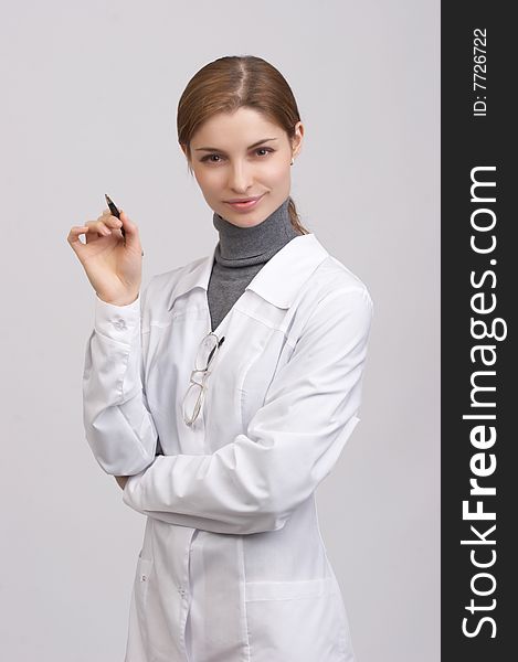 Young beautiful doctor on the white background