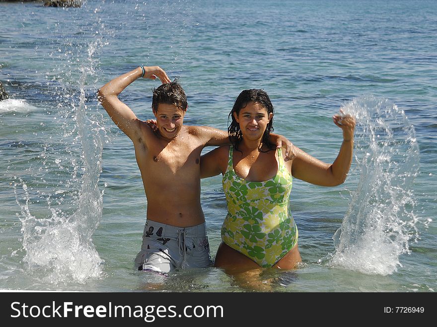 Young couple playing in the sea. Young couple playing in the sea